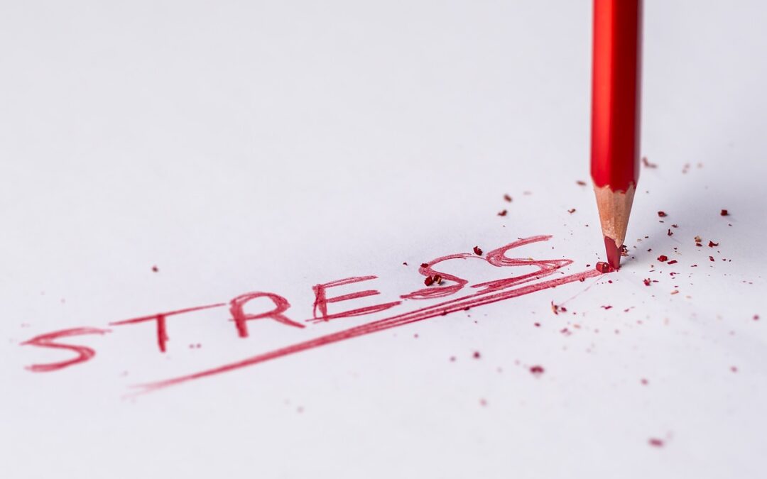 red_pencil_writing_the_word_stressed_on_white_paper