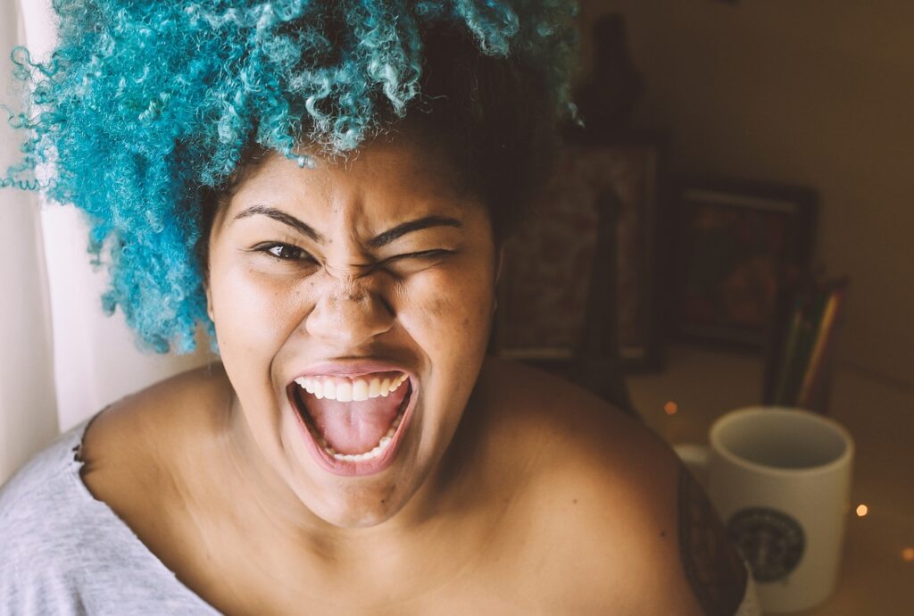 a_woman-with_blue_hair_laughing