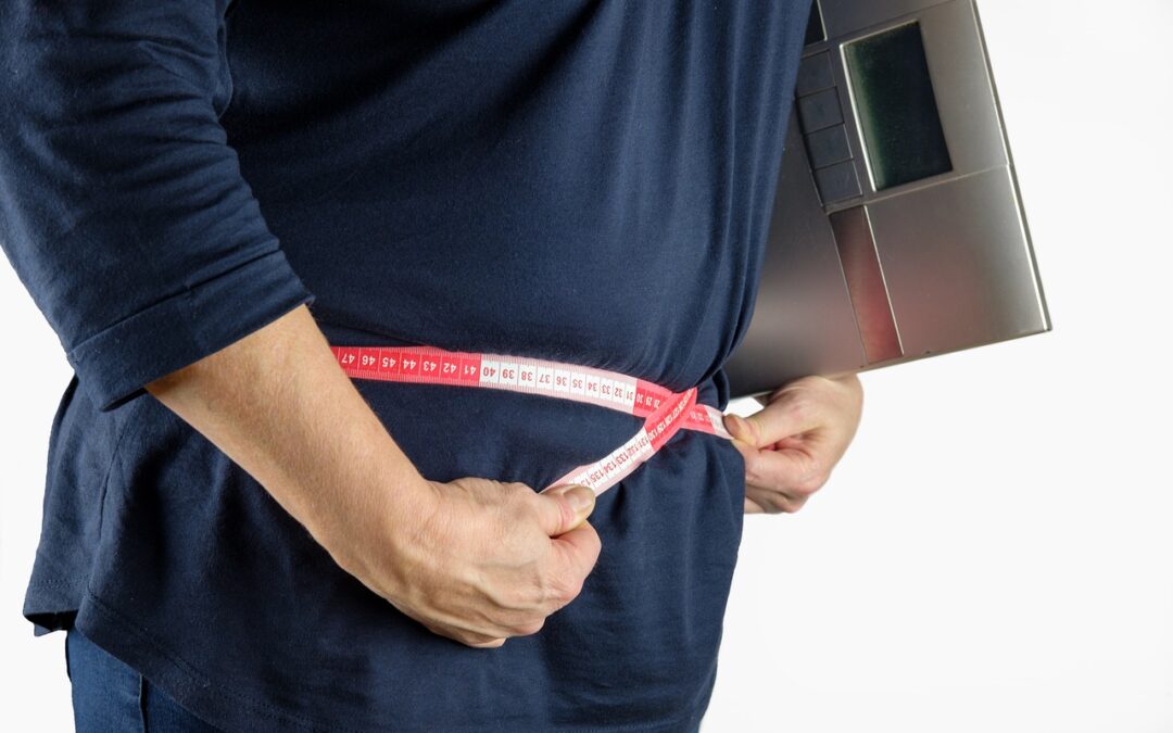 a person measuring their waist