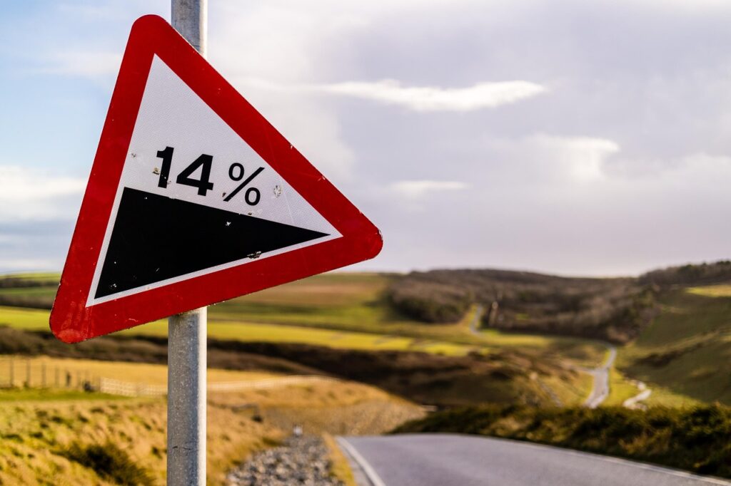 road decline sign on side of road