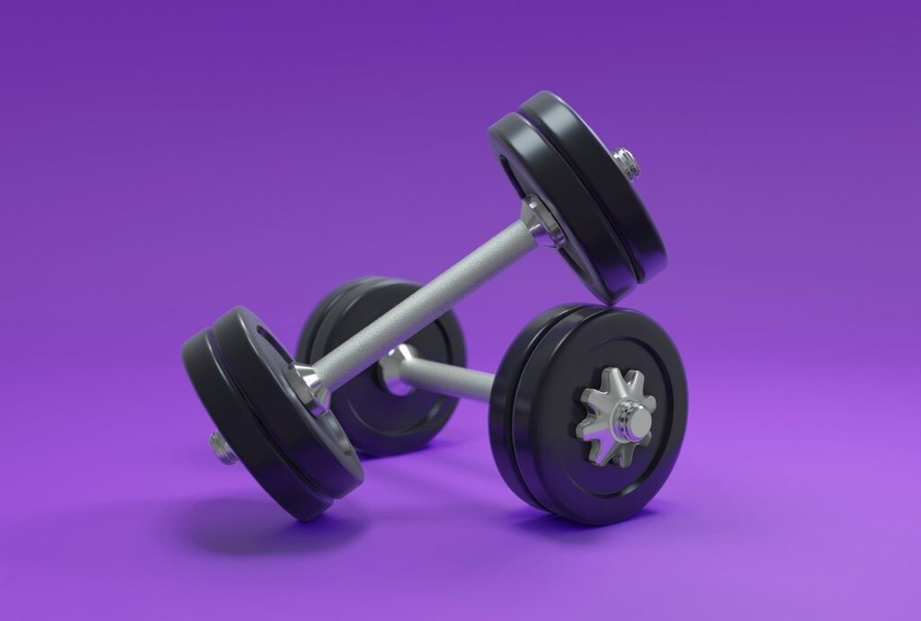 pair of dumbbells on purple background